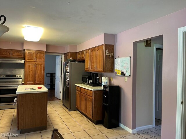 199 Kanawha Rd, Weirton, WV 26062 - kitchen with double oven range, under cabinet range hood, fridge with ice dispenser, light countertops, and light tile patterned flooring