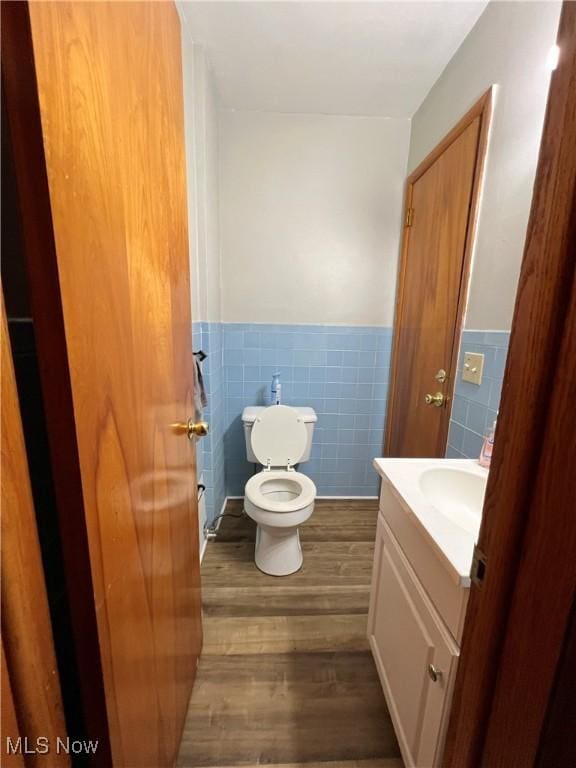 1415 E Main St, Kent, OH 44240 - half bath featuring wood finished floors, vanity, tile walls, and wainscoting