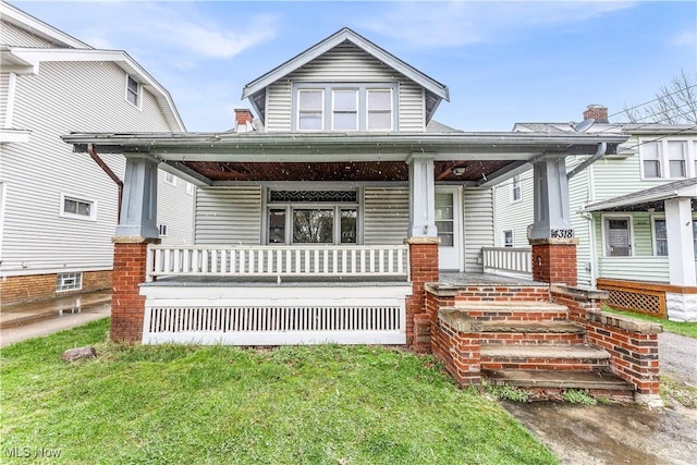 4318 W 50th St, Cleveland, OH 44144 - view of front of house featuring covered porch and a front yard