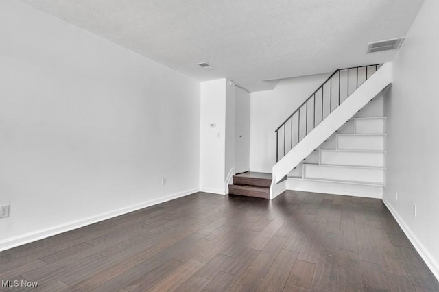 20347 Williamsburg Ct Unit 225B, Middleburg Heights, OH 44130 - unfurnished living room featuring wood finished floors, stairway, and a textured ceiling