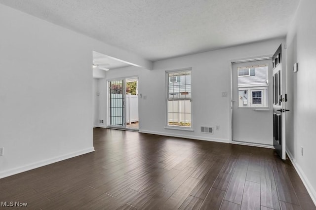 20347 Williamsburg Ct Unit 225B, Middleburg Heights, OH 44130 - unfurnished living room featuring a textured ceiling, dark wood finished floors, and ceiling fan