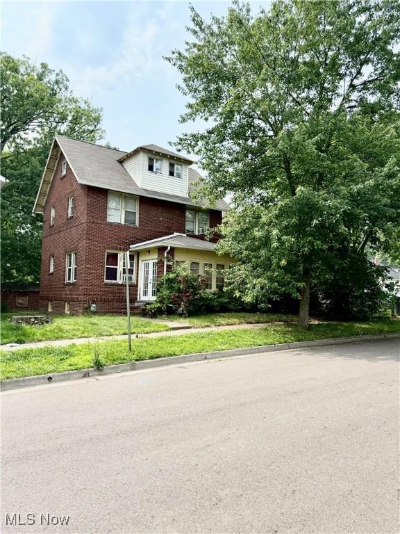 2320 22nd St SW, Akron, OH 44314 - view of front facade featuring brick siding and a front lawn