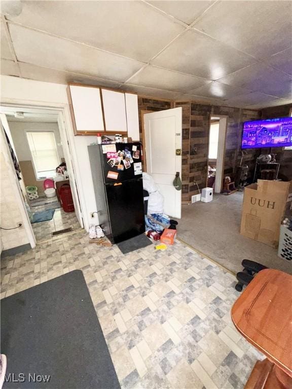 2320 22nd St SW, Akron, OH 44314 - living room with light floors, wood walls, plenty of natural light, and a paneled ceiling