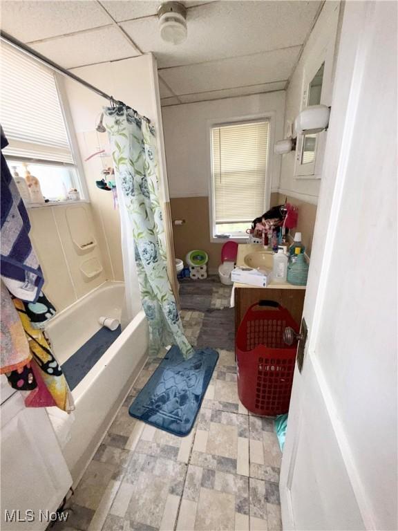 2320 22nd St SW, Akron, OH 44314 - bathroom featuring vanity, shower / bathtub combination with curtain, plenty of natural light, and a drop ceiling