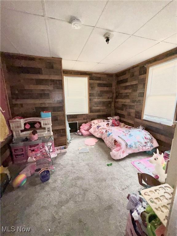 2320 22nd St SW, Akron, OH 44314 - carpeted bedroom featuring wood walls