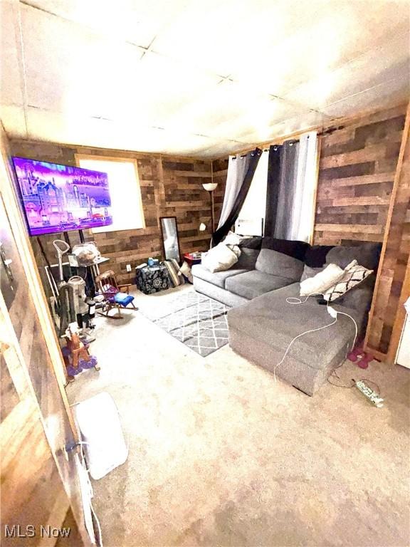 2320 22nd St SW, Akron, OH 44314 - living area with wooden walls and carpet flooring