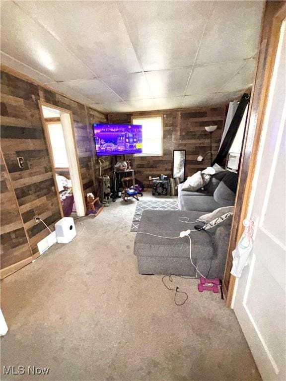 2320 22nd St SW, Akron, OH 44314 - carpeted living area with wooden walls and healthy amount of natural light