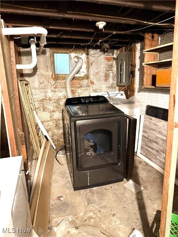 2320 22nd St SW, Akron, OH 44314 - unfinished below grade area featuring electric panel, washer and dryer, and brick wall