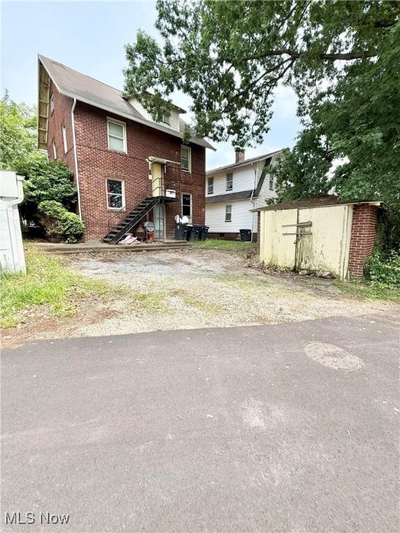 2320 22nd St SW, Akron, OH 44314 - back of property featuring a storage shed and brick siding