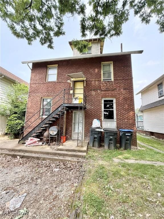2320 22nd St SW, Akron, OH 44314 - back of house featuring brick siding and stairway