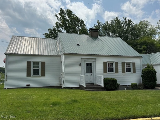 166 Bethesda St, Barnesville, OH 43713 - back of house with a lawn, a chimney, and a metal roof