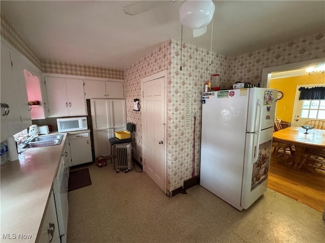 166 Bethesda St, Barnesville, OH 43713 - kitchen featuring white appliances, wallpapered walls, white cabinetry, light countertops, and radiator