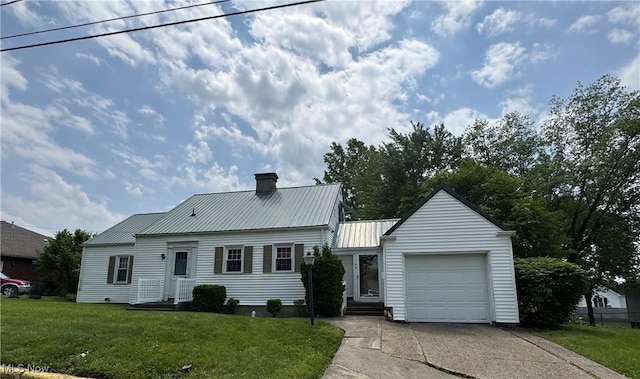 166 Bethesda St, Barnesville, OH 43713 - view of front facade with a chimney, an attached garage, concrete driveway, a metal roof, and a front yard