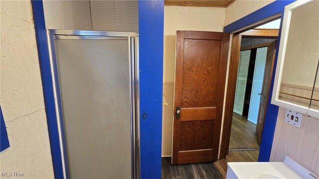 1014 20th St, Parkersburg, WV 26101 - bathroom featuring wood finished floors, a shower stall, and a textured wall