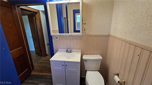 1014 20th St, Parkersburg, WV 26101 - bathroom with wainscoting, vanity, wood finished floors, and a textured wall