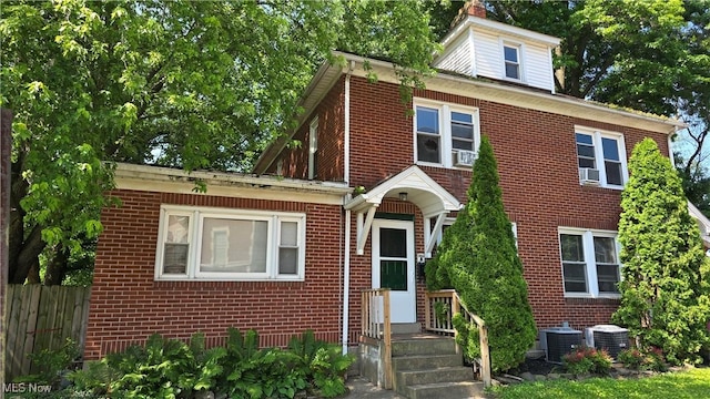 1014 20th St, Parkersburg, WV 26101 - traditional style home featuring brick siding, a chimney, and cooling unit