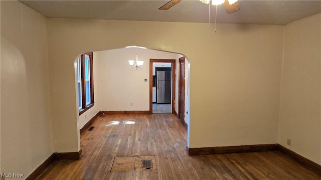 1014 20th St, Parkersburg, WV 26101 - empty room featuring wood-type flooring, arched walkways, a ceiling fan, and a chandelier