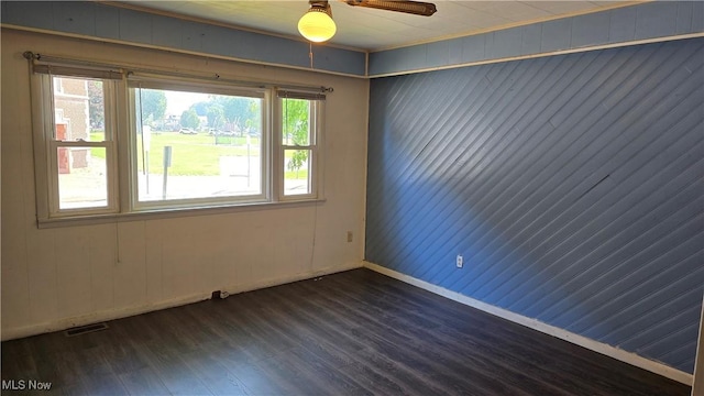 1014 20th St, Parkersburg, WV 26101 - empty room with dark wood-style flooring, ceiling fan, and wood walls