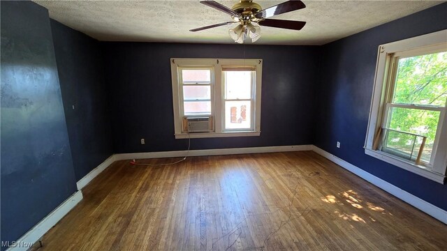 1014 20th St, Parkersburg, WV 26101 - unfurnished room featuring wood finished floors, a textured ceiling, ceiling fan, and cooling unit