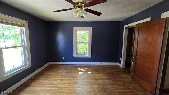 1014 20th St, Parkersburg, WV 26101 - unfurnished room with wood finished floors, a textured ceiling, and ceiling fan