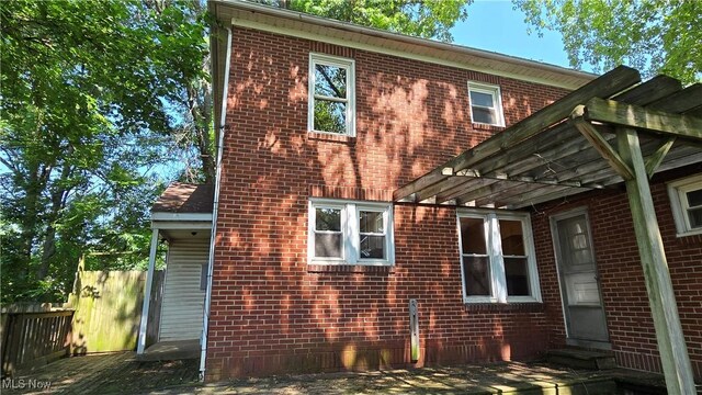 1014 20th St, Parkersburg, WV 26101 - view of side of property with brick siding and a pergola