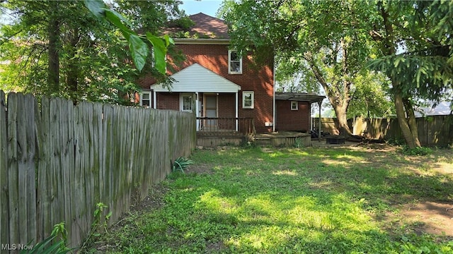 1014 20th St, Parkersburg, WV 26101 - back of house featuring brick siding, a fenced backyard, and a porch
