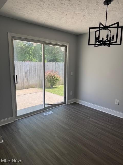 275 Butternut Ln, Berea, OH 44017 - unfurnished dining area with a chandelier, dark wood-style floors, and a textured ceiling
