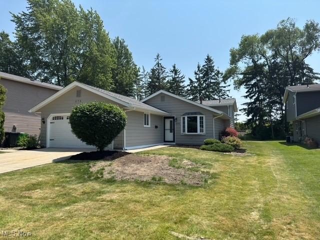 275 Butternut Ln, Berea, OH 44017 - view of front of house featuring a garage, concrete driveway, and a front lawn
