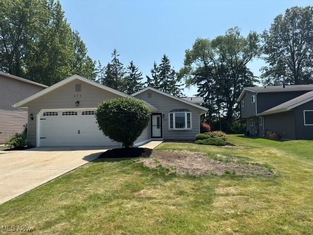 275 Butternut Ln, Berea, OH 44017 - view of front facade featuring concrete driveway, an attached garage, and a front lawn