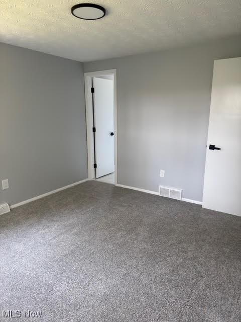 275 Butternut Ln, Berea, OH 44017 - carpeted empty room with baseboards and a textured ceiling