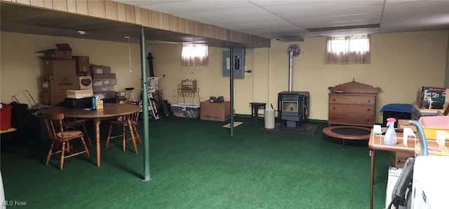 593 Furnace Rd, Conneaut, OH 44030 - below grade area featuring a wood stove, electric panel, and carpet flooring