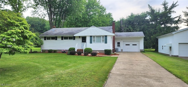 593 Furnace Rd, Conneaut, OH 44030 - ranch-style home featuring concrete driveway, a chimney, an attached garage, and a front yard