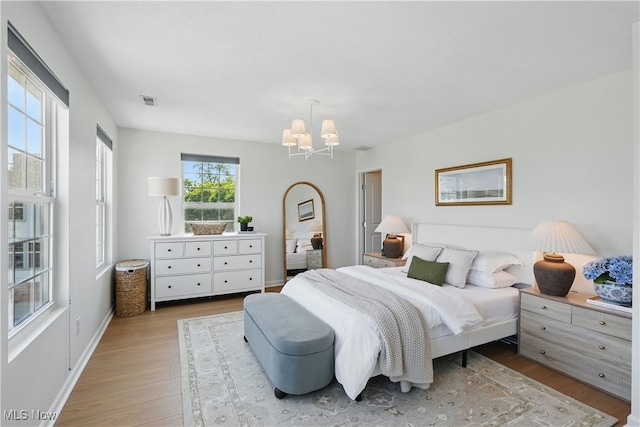 6630 Park Pointe Ct, Pepper Pike, OH 44124 - bedroom featuring a chandelier and wood finished floors