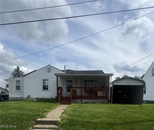 1015 Belford St, Caldwell, OH 43724 - view of front facade with a porch, a front lawn, and a detached carport