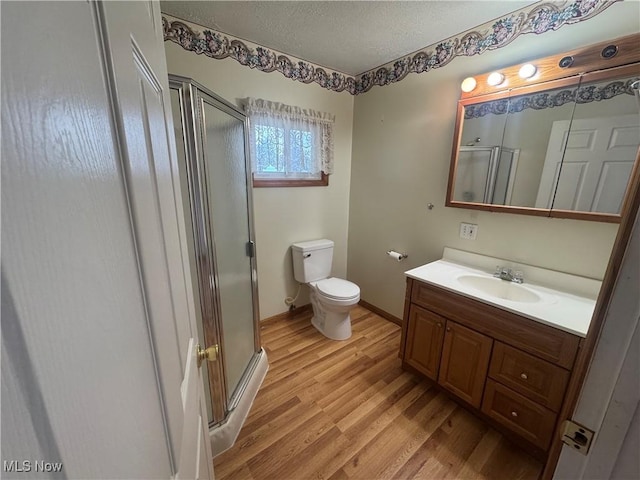 1015 Belford St, Caldwell, OH 43724 - bathroom with a shower stall, wood finished floors, vanity, and a textured ceiling