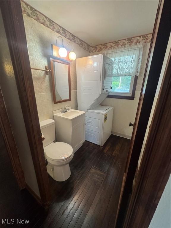 1015 Belford St, Caldwell, OH 43724 - half bath with estacked washer and dryer, hardwood / wood-style flooring, and vanity