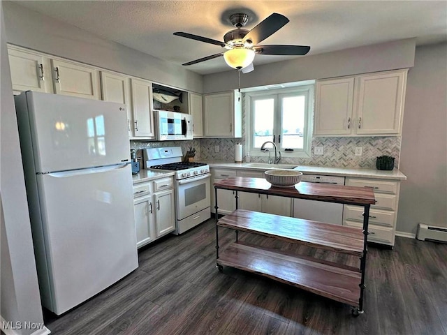 7374 Eisenhower Dr Unit 5, Boardman, OH 44512 - kitchen featuring white appliances, decorative backsplash, and white cabinetry