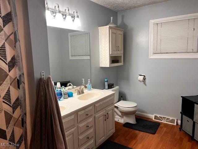 67682 Morristown Flushing Rd, Belmont, OH 43718 - bathroom featuring double vanity and wood finished floors