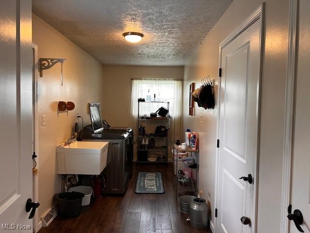67682 Morristown Flushing Rd, Belmont, OH 43718 - washroom with a textured ceiling, washing machine and dryer, and dark wood-style floors