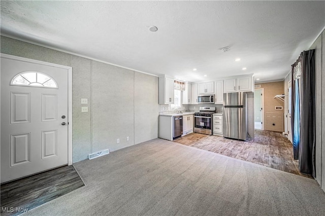 8323 Eagle Rd Unit 42, Kirtland, OH 44094 - kitchen featuring appliances with stainless steel finishes, plenty of natural light, light colored carpet, white cabinets, and recessed lighting