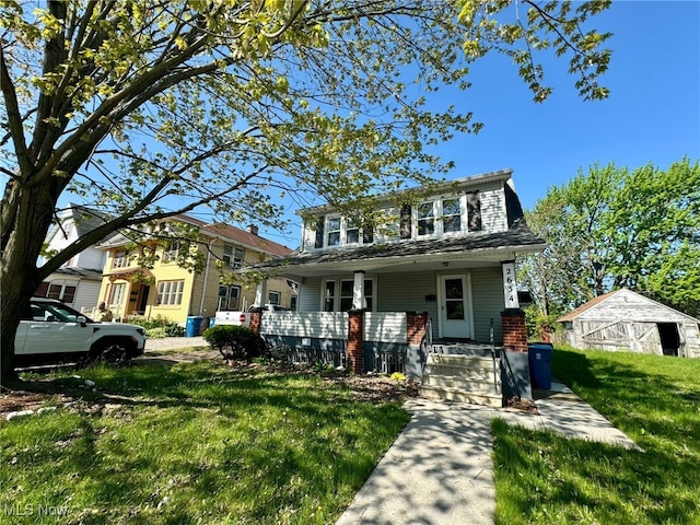 2634 Apple Ave, Lorain, OH 44055 - view of front of property with a porch, a front yard, and an outdoor structure