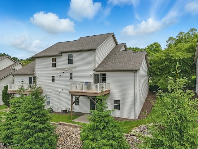 91 Falling Water Cir, Munroe Falls, OH 44262 - back of property with roof with shingles, a patio area, and a wooden deck
