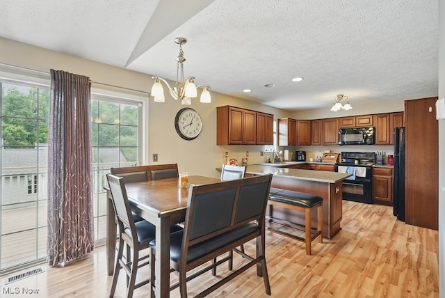 91 Falling Water Cir, Munroe Falls, OH 44262 - dining room featuring a chandelier, a textured ceiling, light wood-style floors, and recessed lighting