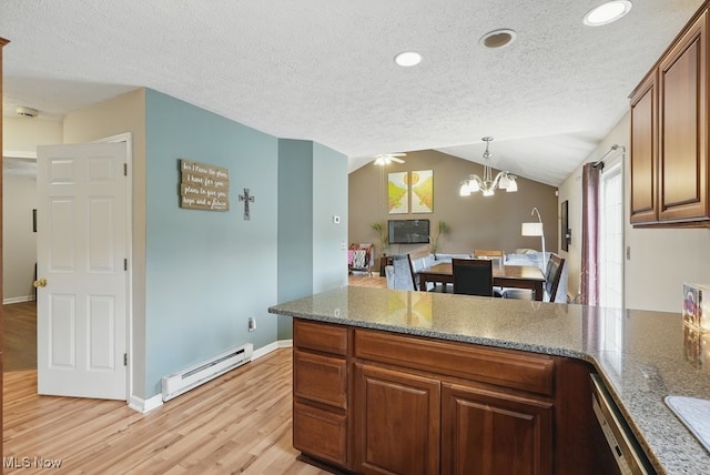 91 Falling Water Cir, Munroe Falls, OH 44262 - kitchen with a baseboard heating unit, light wood-type flooring, a peninsula, a chandelier, and a textured ceiling