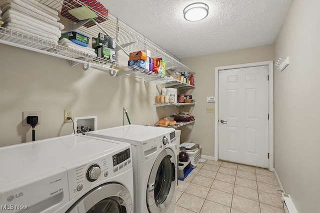 91 Falling Water Cir, Munroe Falls, OH 44262 - washroom featuring washing machine and dryer, light tile patterned flooring, a textured ceiling, and a baseboard heating unit