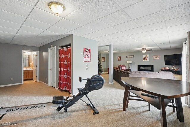 91 Falling Water Cir, Munroe Falls, OH 44262 - workout room featuring light carpet, a paneled ceiling, ceiling fan, and a glass covered fireplace