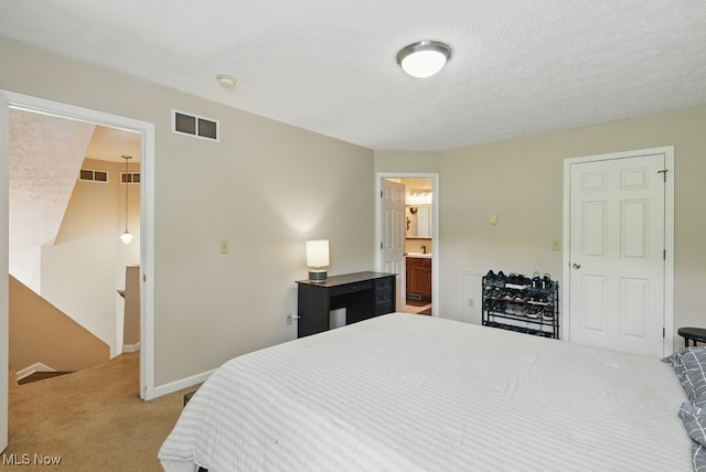 91 Falling Water Cir, Munroe Falls, OH 44262 - bedroom with light carpet, ensuite bathroom, a spacious closet, and a textured ceiling