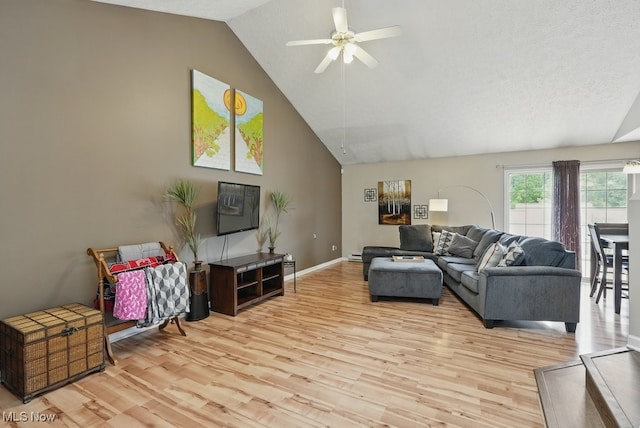 91 Falling Water Cir, Munroe Falls, OH 44262 - living area featuring light wood-style floors, ceiling fan, high vaulted ceiling, and a baseboard heating unit