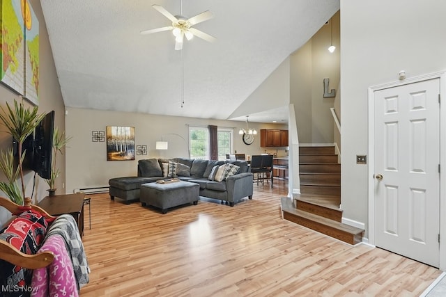 91 Falling Water Cir, Munroe Falls, OH 44262 - living area with high vaulted ceiling, a baseboard radiator, stairs, light wood-style floors, and a chandelier
