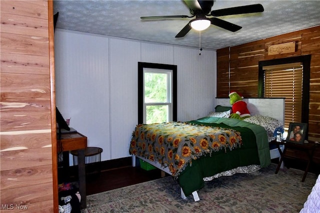 5041 W S Range Rd, Salem, OH 44460 - bedroom featuring a textured ceiling, wood walls, and a ceiling fan